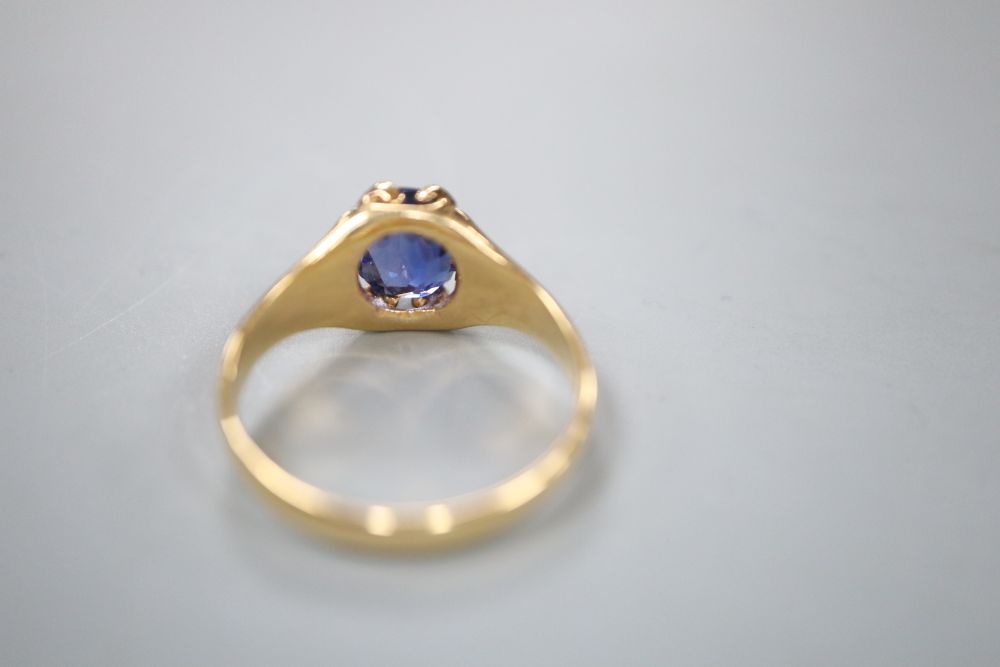 A yellow metal and claw set oval cut sapphire ring, the shank with fluted shoulders, size O/P, gross 4.9 grams.
